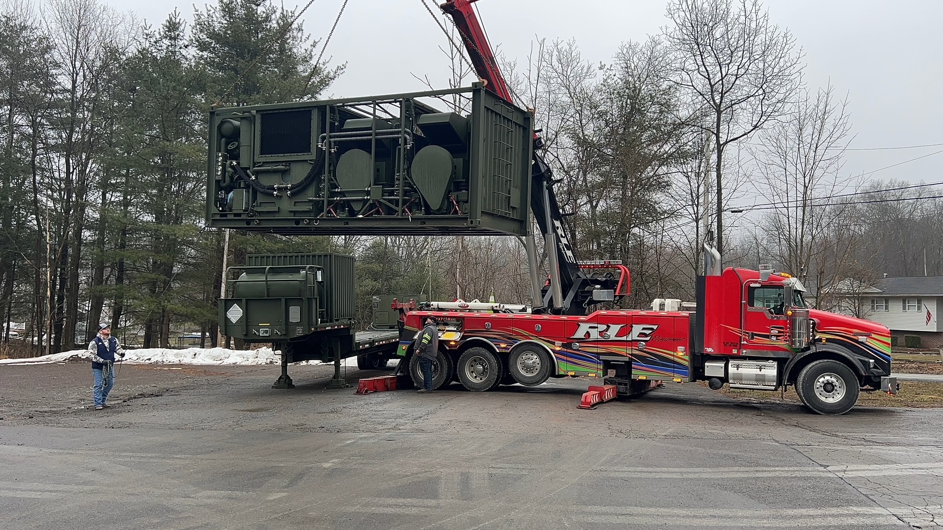 Crane hoisting LADS module onto trailer chassis during field service
